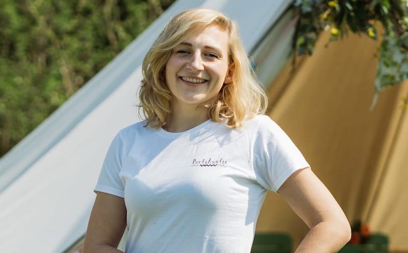 Carla standing in front of a tent